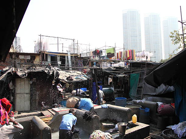 Mumbai, India - December 29, 2014:Dhobi Ghat is known as the world's largest outdoor laundry. Man is washing the laundry.