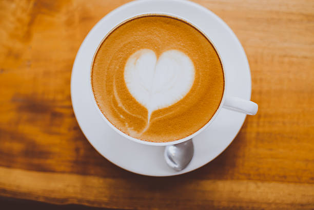 istock hot milk art coffee on wooden table 625683334