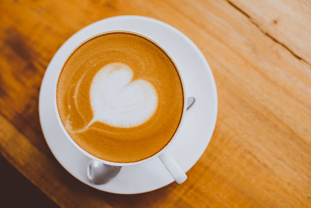 istock hot milk art coffee on wooden table 625683336
