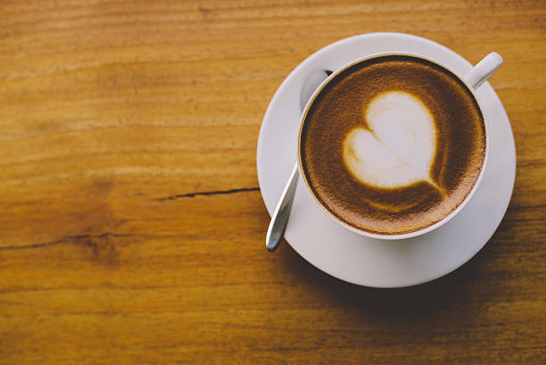 istock Coffee cup top view on wooden table background 625684146