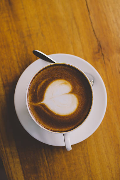 istock Coffee cup top view on wooden table background 625684332