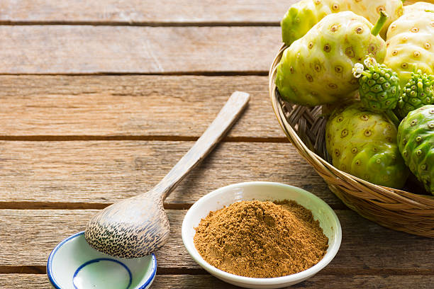 Noni Fruit And Noni Powder On Wooden Table Stock Photo - Download