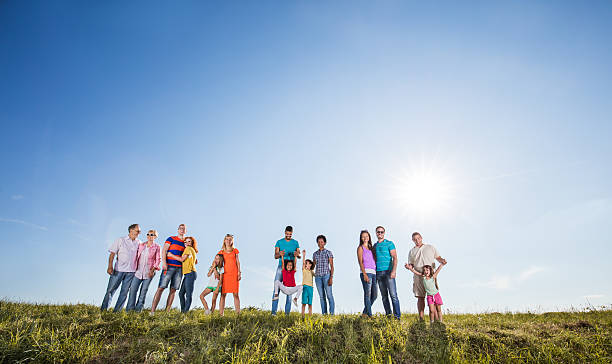 istock Large group of mixed age people standing in a meadow. 625685920