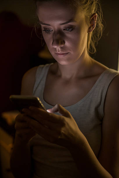 istock young woman texting on smartphone at home  at night 625688494