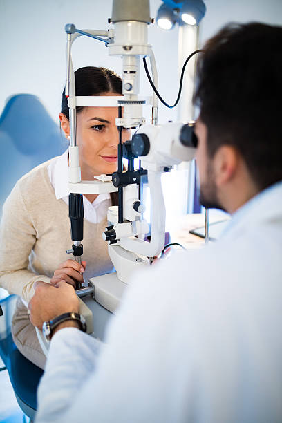 Young woman having her eyes examined by optometrist.