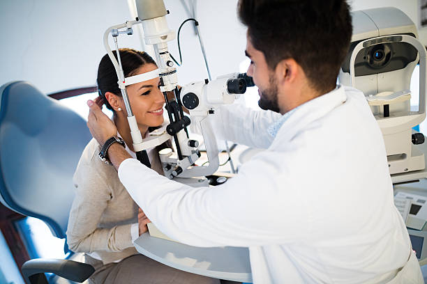istock Young woman having her eyes examined by optometrist. 625690644