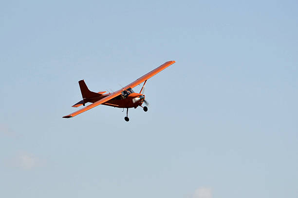 istock In the sky the small orange plane flies. 625697546