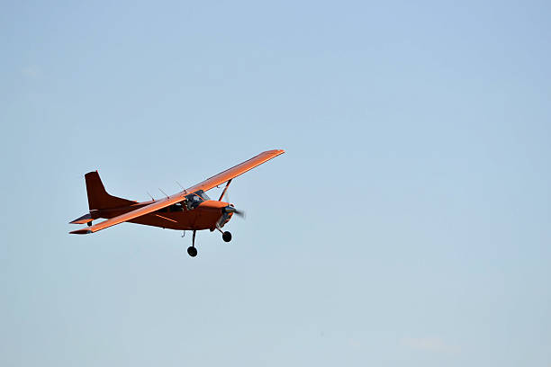 istock In the sky the small orange plane flies. 625697562