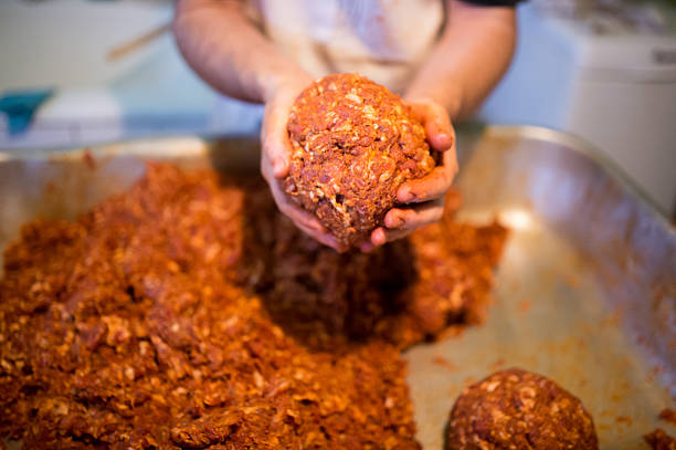 istock Unrecognizable man holding meat ball in his hands, close up. 625700384