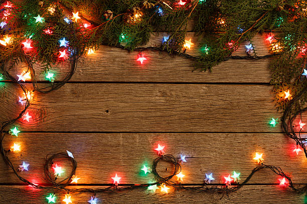 istock christmas lights border on wood background 625701200