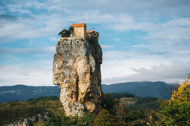 Katskhi pillar. Georgian landmarks. The church on a rocky cliff. Katskhi pillar. Georgian landmarks. Man's monastery near the village of Katskhi. The orthodox church and the abbot cell on a rocky cliff. Imereti, Georgia. Georgian Meteora monastery photos stock pictures, royalty-free photos & images