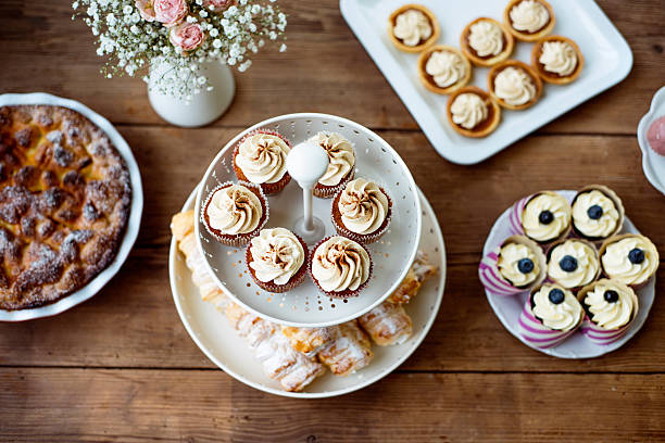 istock Table with cupcakes, tarts, pie and horn pastries. 625703696