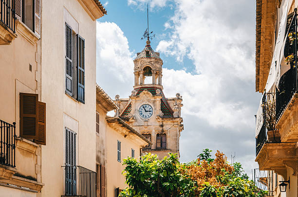 Town hall in Old Town, Alcudia, Mallorca, Spain Architecture of Majorca. The tower with big clock of City town hall in Old Town of Alcudia, Mallorca, Balearic island, Spain bay of alcudia stock pictures, royalty-free photos & images