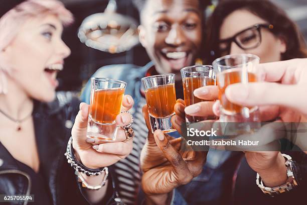 Happy Friends Drinking Shots Stock Photo - Download Image Now - Shot Glass, Alcohol - Drink, Drinking