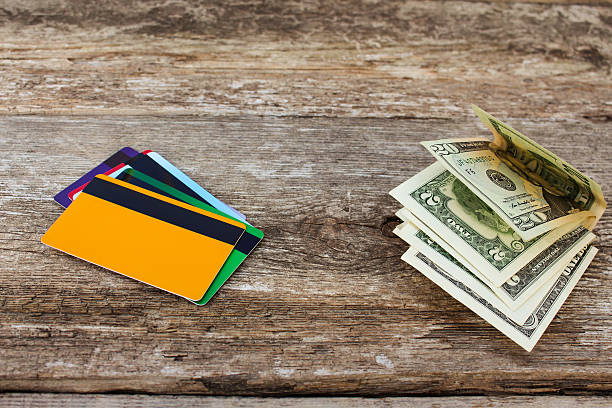 istock Credit card and dollars on wooden background 625705972