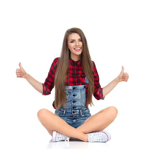 istock Sitting Girl Giving Thumbs Up 625706126