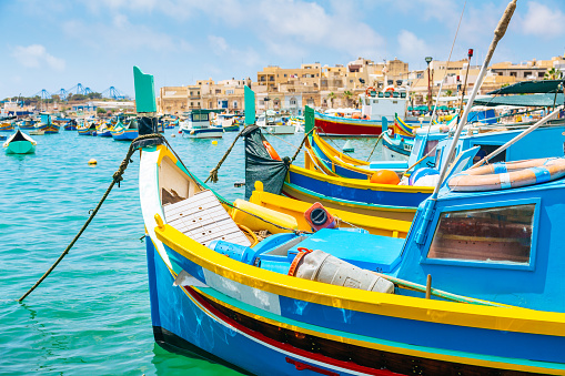 Marsaxlokk Harbor. Marsaxlokk in Malta is a fishing village in the Southpart famous for its fish market, colourful boats and fish restaurants.