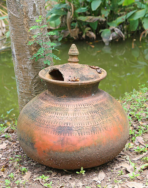 istock Old and broken clay jar in the garden 625715098
