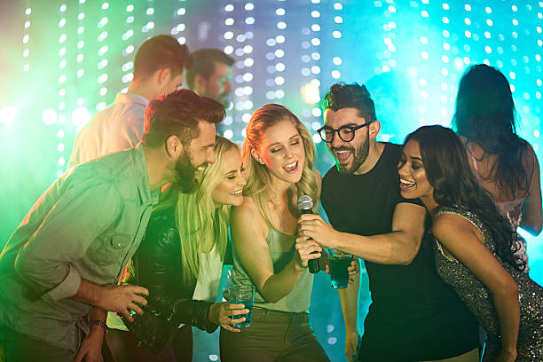There’s a superstar in all of us Shot of a group of friends singing karaoke at a party karaoke photos stock pictures, royalty-free photos & images