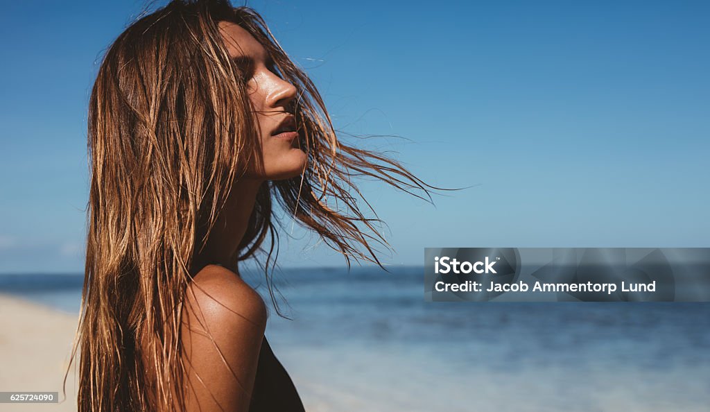 Beautiful young woman on the beach Close up portrait of beautiful young woman on the beach. Young caucasian female model on the sea shore. Beach Stock Photo