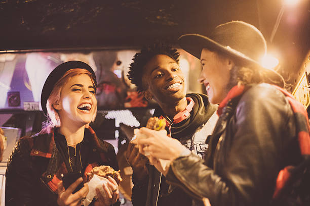 istock Multi ethnic friends eating burgers in pub 625726354