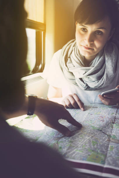 istock Young woman planning a trip, using smartphone, travelling by train 625726726