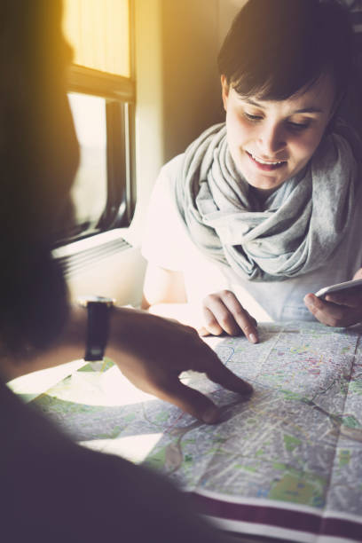 istock Young woman planning a trip, using smartphone, travelling by train 625727128
