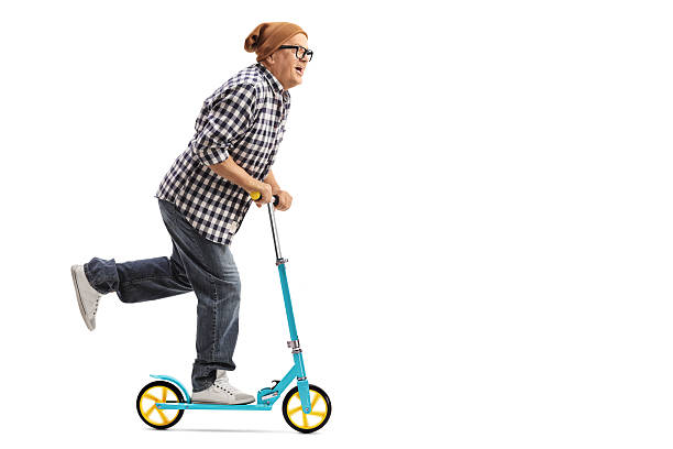 istock Cool mature man riding a scooter 625727288