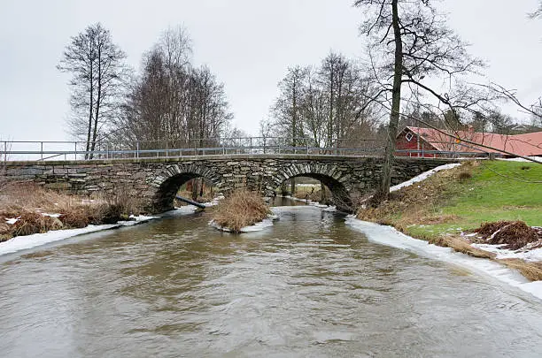 old stonebridge over the cold water one grey day in early spring