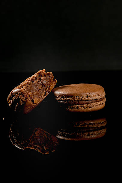 istock brown tasty broken macaroon, close up on Black background 625734288