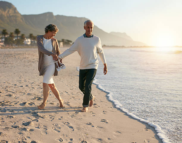 istock Senior couple walking leisurely on the beach 625735926