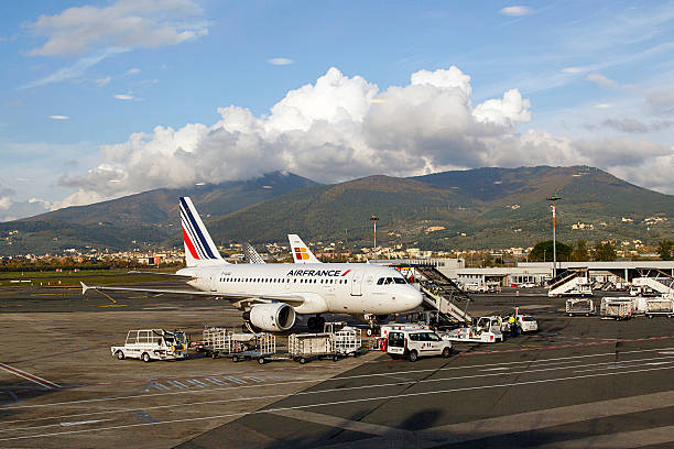 Air France at Florence Airport Florence, Italy: November 20, 2016: An Air France airbus is having luggage stowed before passengers board the flight at Florence Airport. Air France is the French flag carrier headquartered in Tremblay-en-France,. It is a subsidiary of the Air France–KLM Group.  florence italy airport stock pictures, royalty-free photos & images
