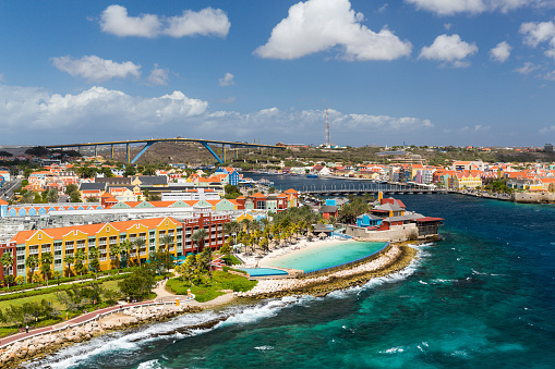 The Queen Emma Bridge is a pontoon bridge across St. Anna Bay in CuraÃ§ao. It connects the Punda and Otrobanda quarters of the capital city, Willemstad. The bridge is hinged and opens regularly to enable the passage of oceangoing vessels.
