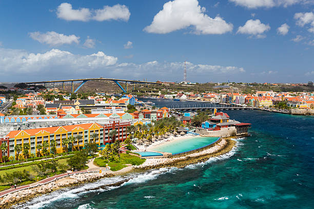 Willemstad in Curacao and the Queen Emma Bridge The Queen Emma Bridge is a pontoon bridge across St. Anna Bay in CuraÃ§ao. It connects the Punda and Otrobanda quarters of the capital city, Willemstad. The bridge is hinged and opens regularly to enable the passage of oceangoing vessels. curaçao stock pictures, royalty-free photos & images