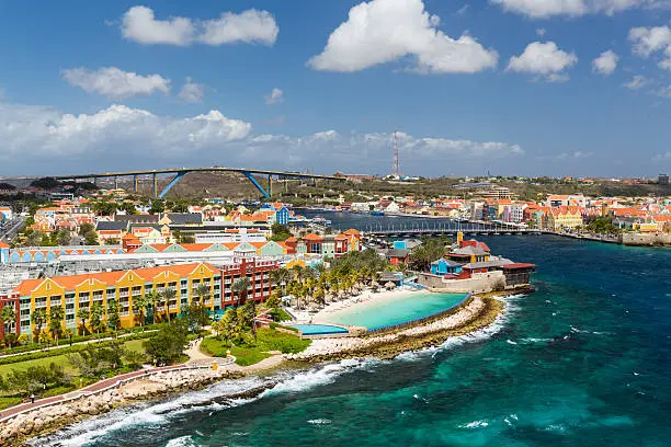 The Queen Emma Bridge is a pontoon bridge across St. Anna Bay in CuraÃ§ao. It connects the Punda and Otrobanda quarters of the capital city, Willemstad. The bridge is hinged and opens regularly to enable the passage of oceangoing vessels.