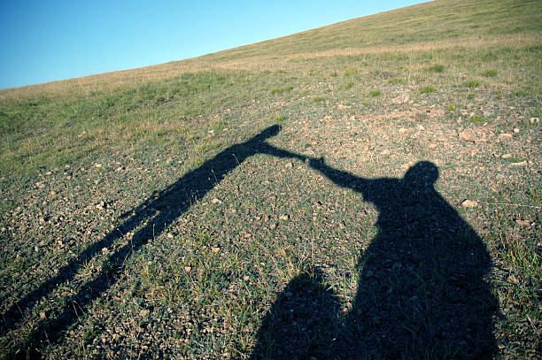 Woman hiker taking photo on rocky mountains