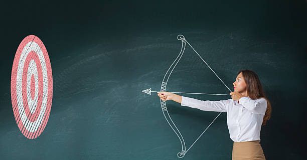 Businesswoman with bow and arrow