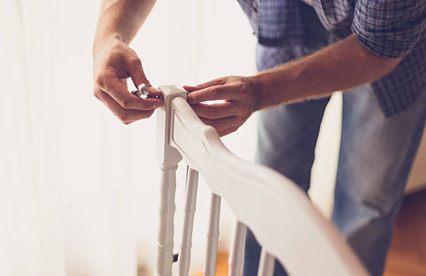 istock Close up of a single dad assembling crib 625740130