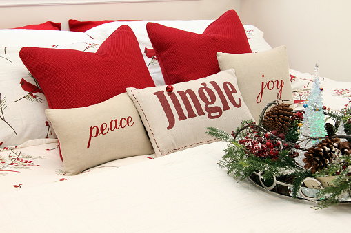 Christmas bedroom with holiday cushions.