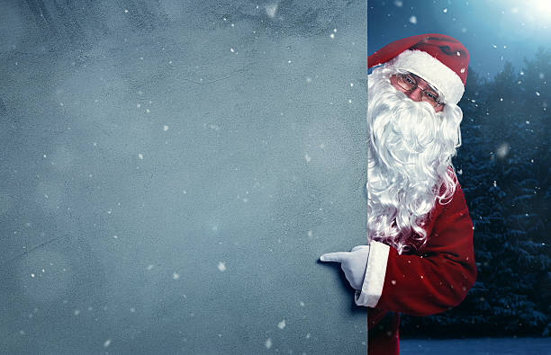 istock Santa Claus pointing on blank wall 625741316