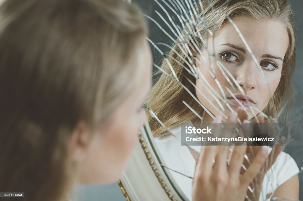 Woman touching broken mirror Beautiful woman with mental disorder touching broken mirror Mirror - Object Stock Photo