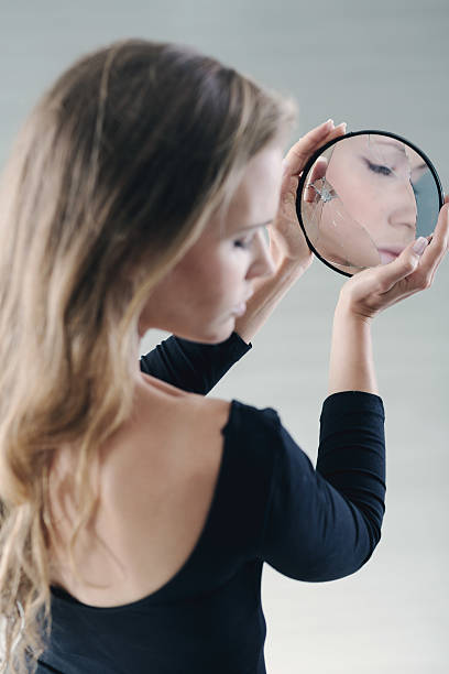 istock Teenager holding small broken mirror 625741374