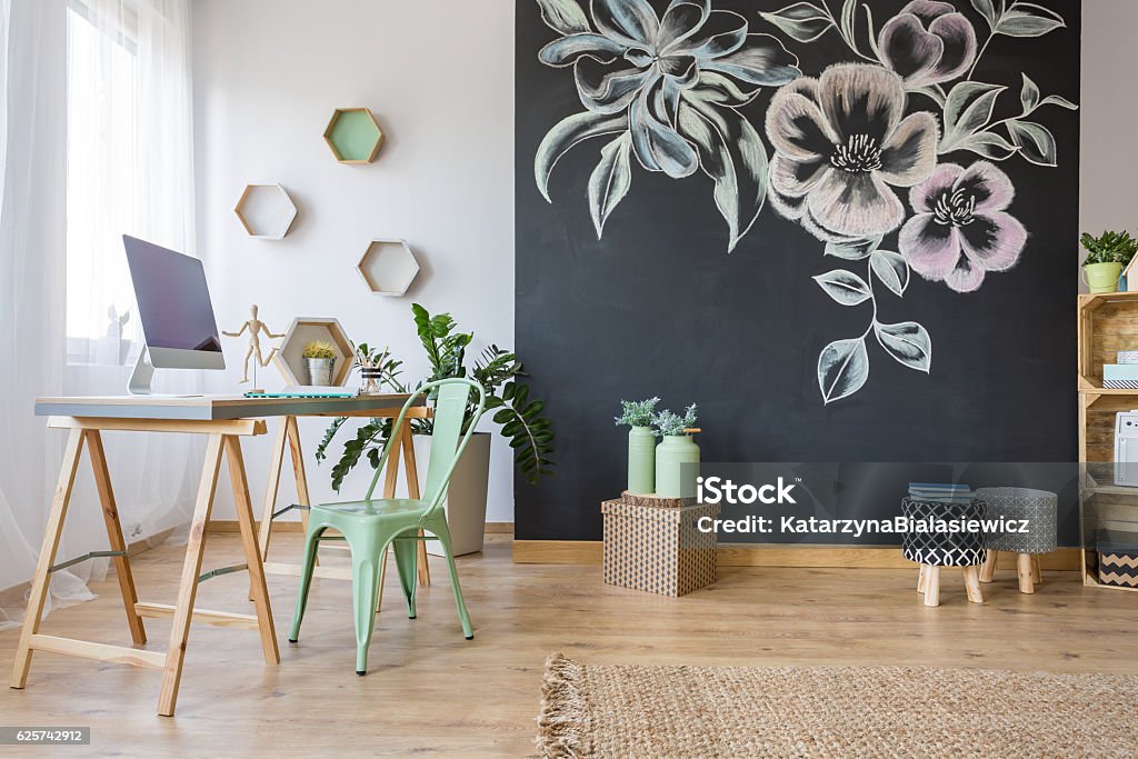 Spacious room with desk Spacious room with desk, chair and decorative chalkboard wall Wall - Building Feature Stock Photo