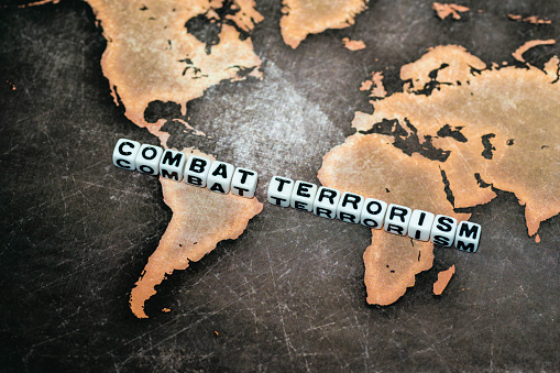 COMBAT TERRORISM on grunge world map