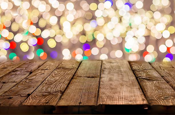 istock Old empty table with christmas lights in the background 625749402