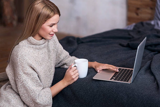 istock Young woman using laptop with coffee 625750256