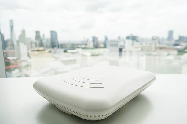 isolated access point on the office desk with city view stock photo