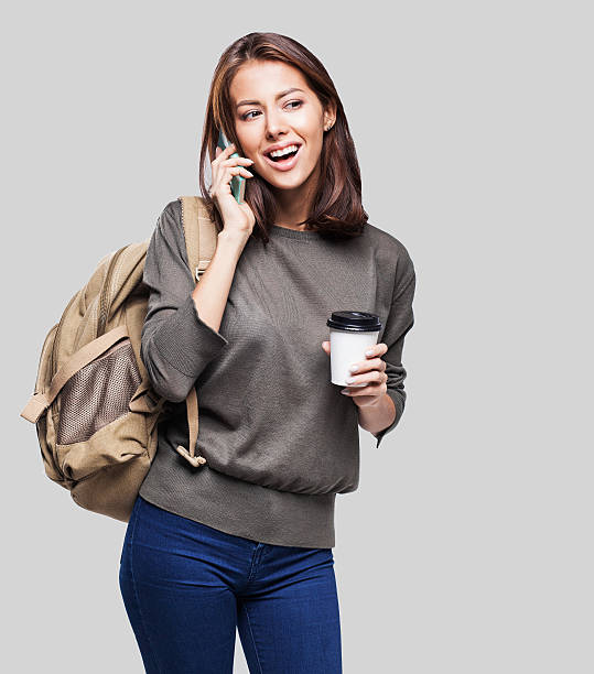 Happy young student girl using smart phone