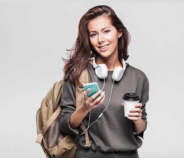 Happy young student girl using smart phone