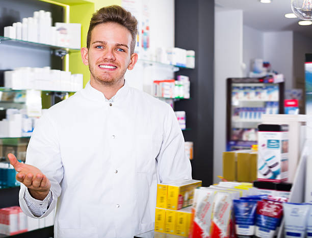istock Young pharmacist standing among shelves 625752686